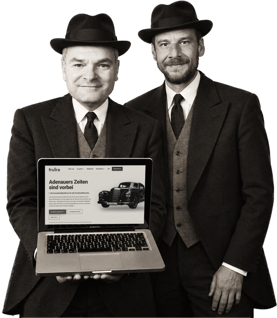 Wolfgang Baumann and Samuel Fürle, founders of frutra GbR, with a laptop showing the frutra home page